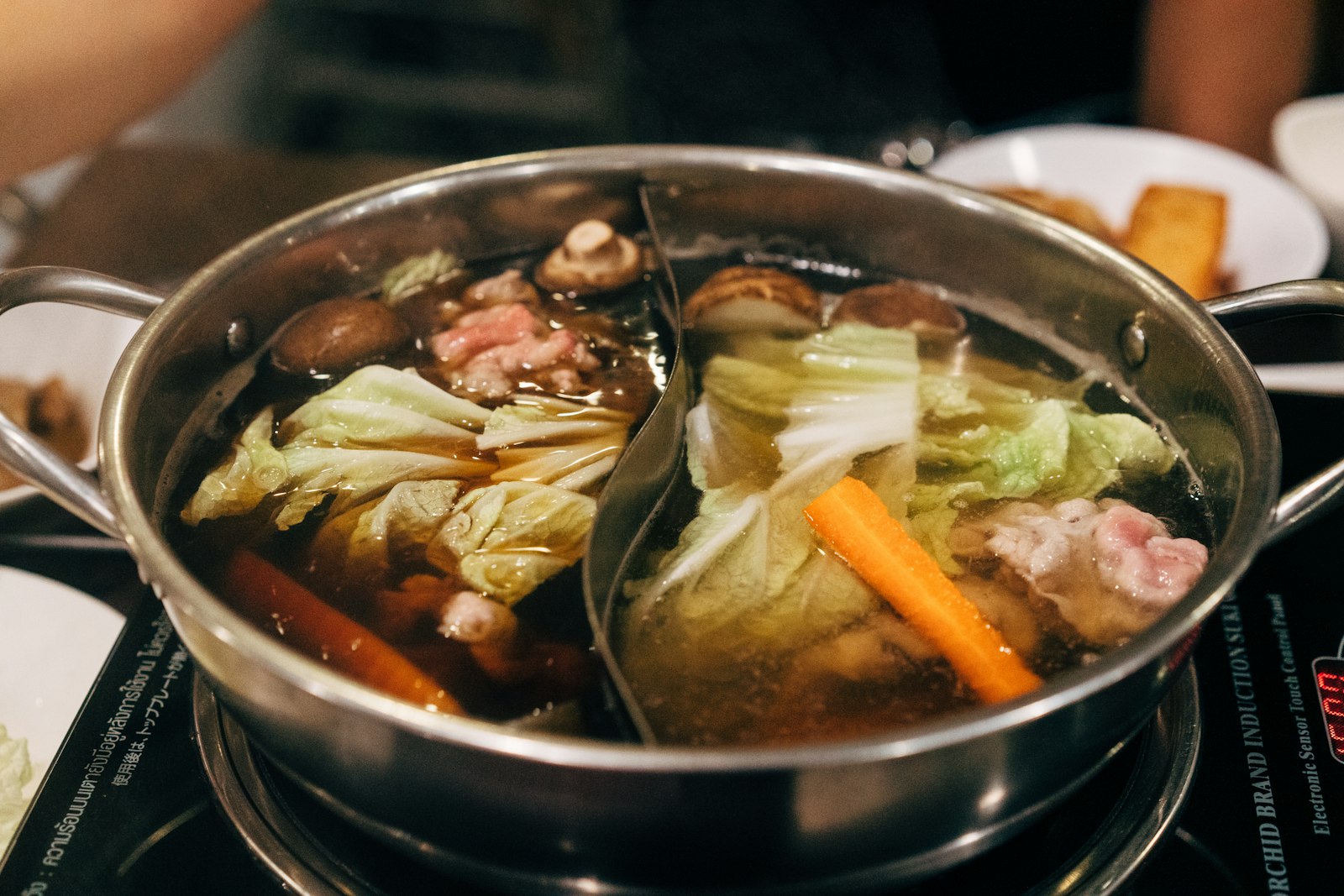 キャベツと豚肉を煮込んだ鍋料理。土鍋にキャベツと豚肉、にんじんが入っている